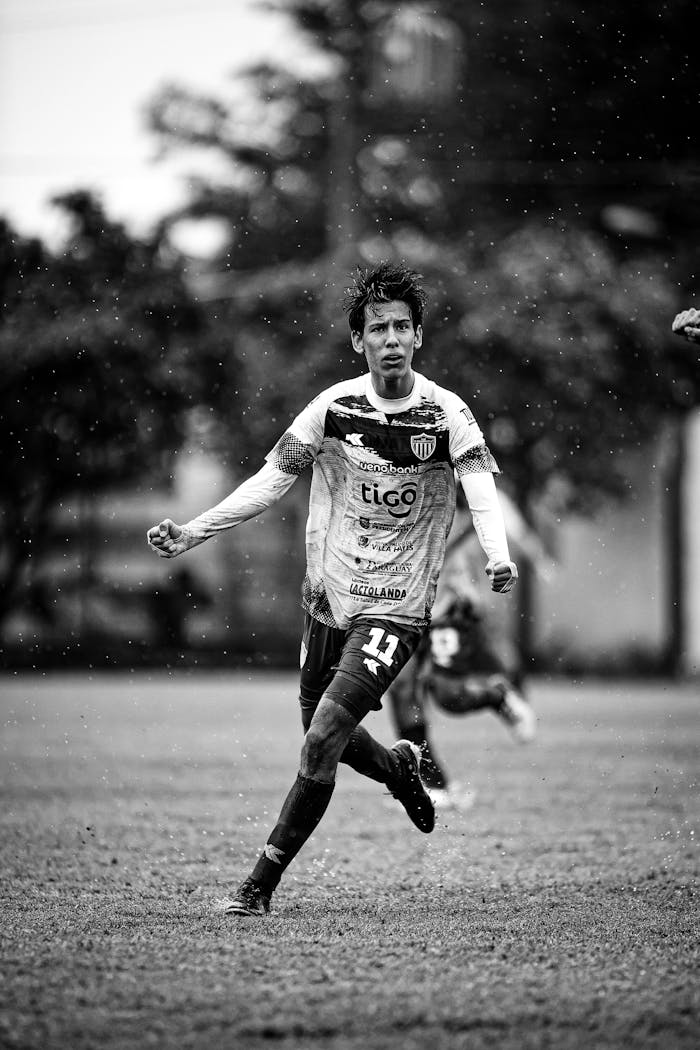 Mastering the First Impression: Your intriguing post title goes here Shot of a soccer player in action in Paraguay, captured in dramatic black and white.